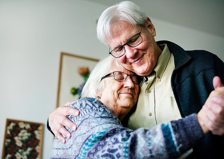 A senior couple dancing together in their home. — Rawpixel.com // Shutterstock