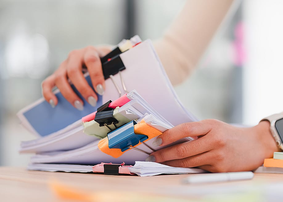 Person organizing sets of documents. — PRIME STOCK LAB // Shutterstock