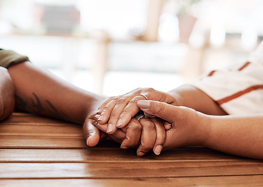 A couple's hands holding each other as an act of empathy. — PeopleImages // Shutterstock
