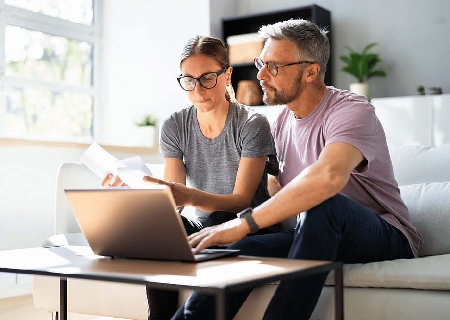 Couple doing taxes on a computer. — Andrey_Popov // Shutterstock