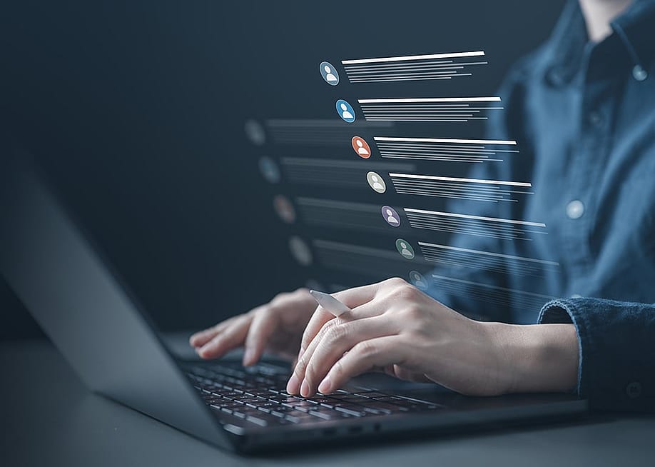 Person typing on a laptop illustrated with a list of contacts software graphics. — Garun .Prdt // Shutterstock