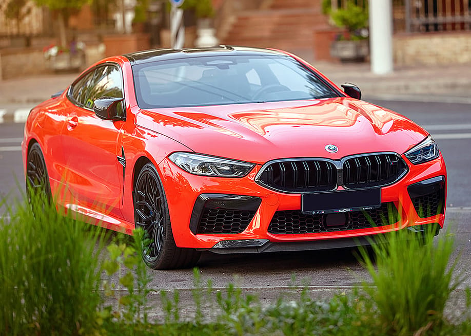 A red BMW M8 car. — Tricky_Shark // Shutterstock