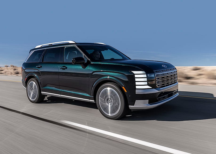 A Hyundai Palisade Hybrid SUV on the road. — Hyundai