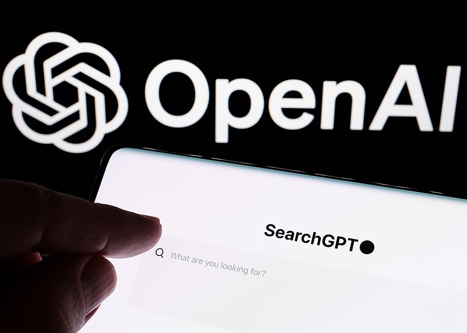 Hand pointing at SearchGPT bar with the logo of OpenAI in the background. — Ascannio // Shutterstock