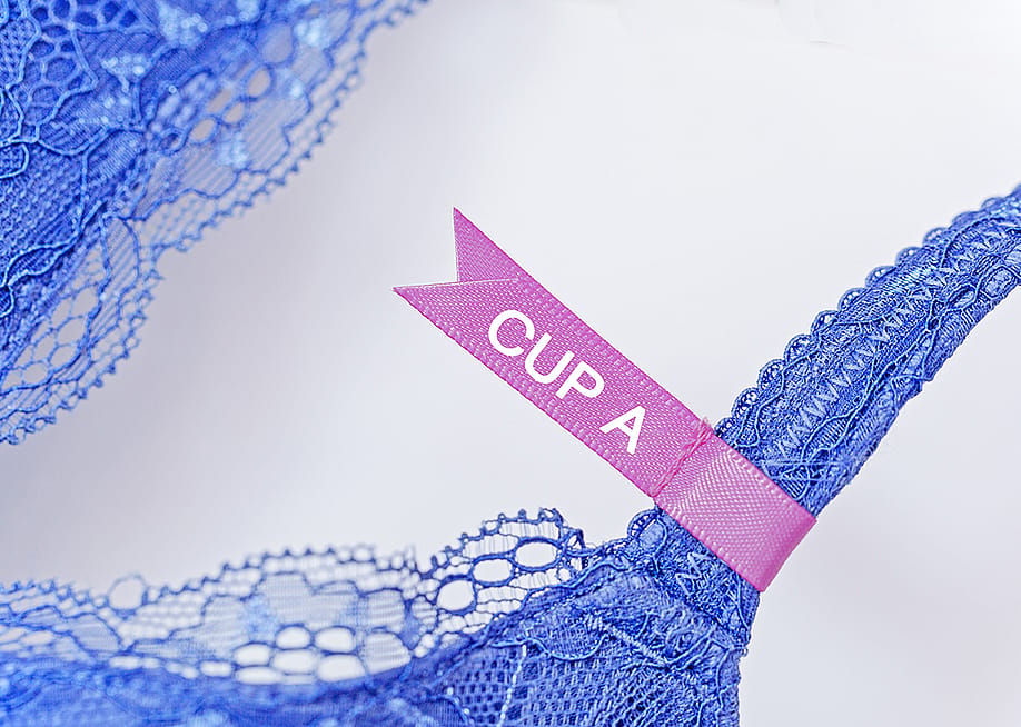 A pink 'cup A' label on a lace bra. — nnattalli // Shutterstock