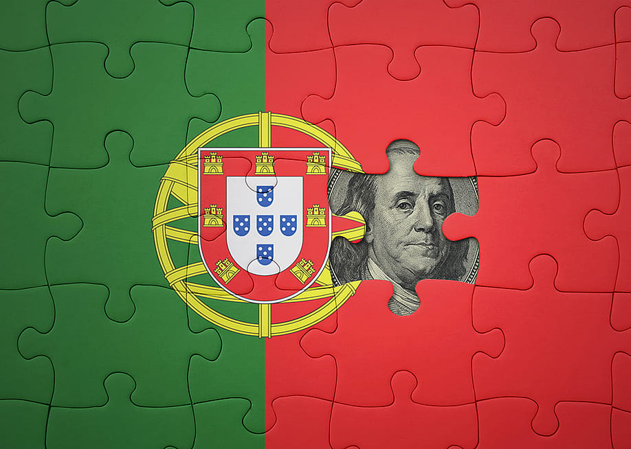 Flag of Portugal in puzzle pieces revealing a US dollar banknote. — esfera // Shutterstock