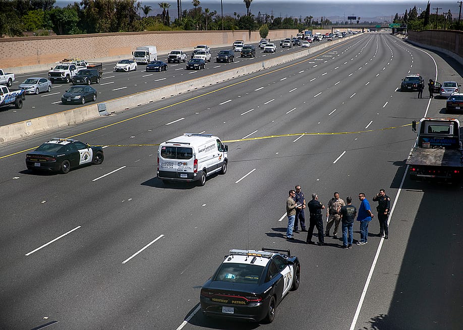 Crime scene investigators gather on the side of California Highway where a 6-year-old boy was fatally shot during a road rage incident on 55 Freeway in Orange. — Allen J. Schaben // Los Angeles Times via Getty Images