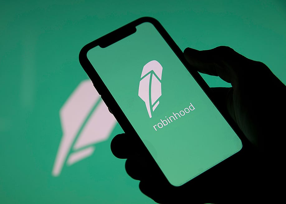 Robinhood, a financial investing app, and its logo displayed on a smartphone. — Ink Drop // Shutterstock