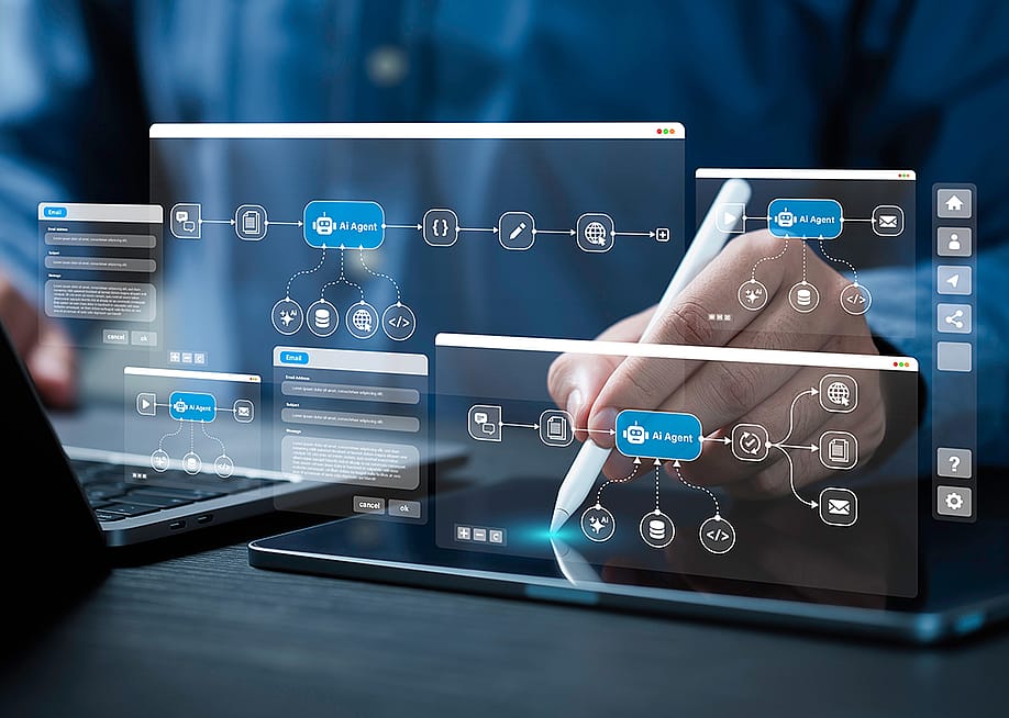 AI workflow automation graphics over a person using a laptop and digital tablet at work. — Deemerwha studio // Shutterstock