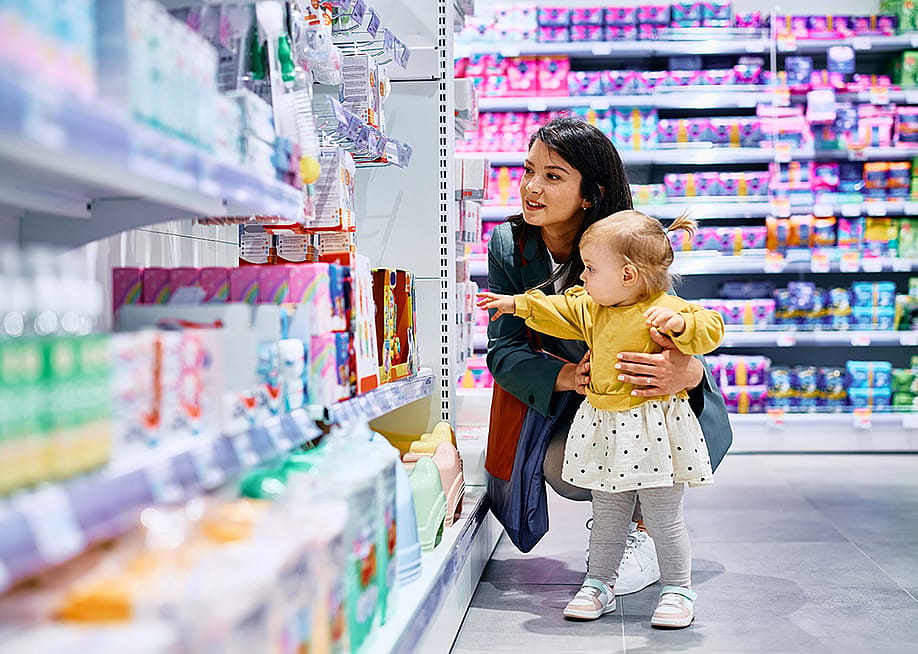 A mother and her young daughter shopping in a drugstore. — Drazen Zigic // Shutterstock