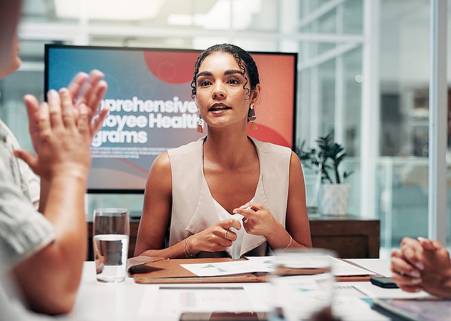 A businesswoman leading a boardroom meeting. — PeopleImages // Shutterstock