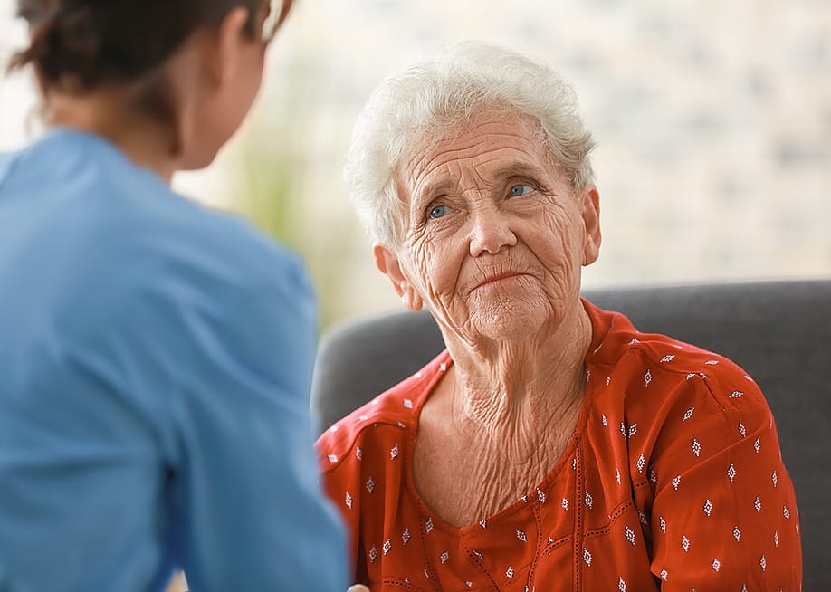 A senior woman facing her nurse. — Pixel-Shot // Shutterstock