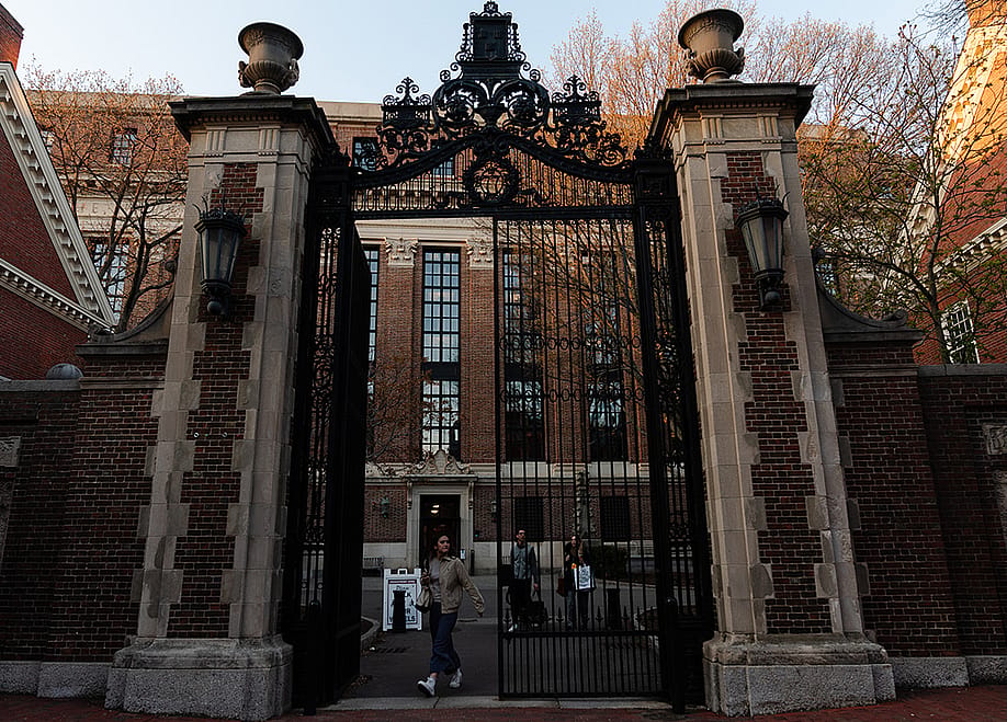 Students go in and out of the Harvard University gate. — Sophie Park // Getty Images