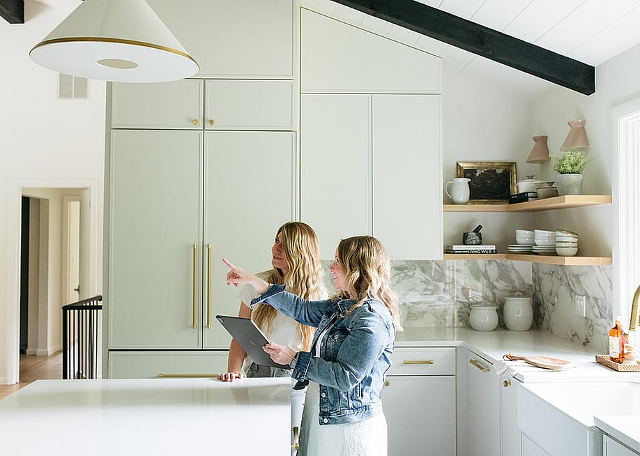 Two people checking out a design or structure in a kitchen. — Curated Nest; Courtesy of Houzz