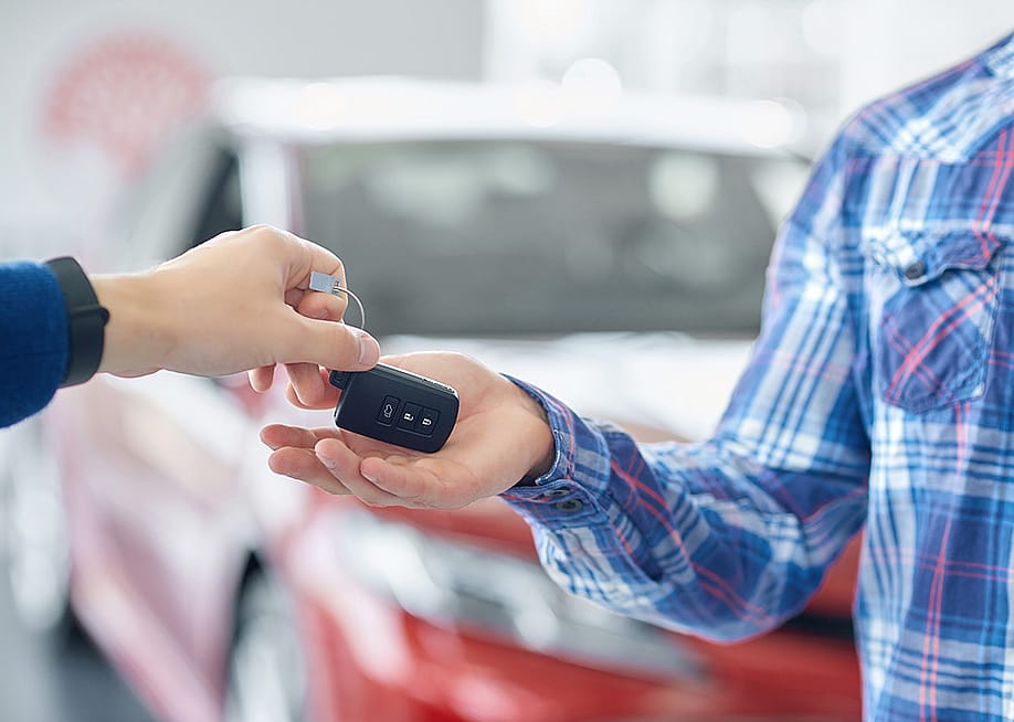 Customer taking new car keys after purchase. — Serhii Bobyk // Shutterstock
