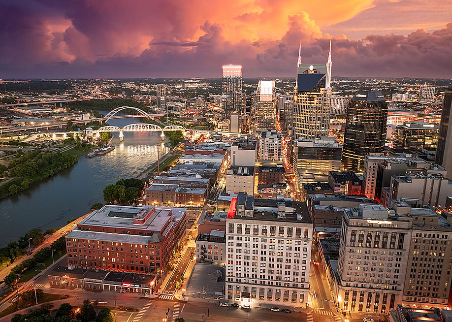 Aerial view of the high-rise buildings and waterfront area by the Cumberland River in Nashville, Tennessee. — Bilanol // Shutterstock