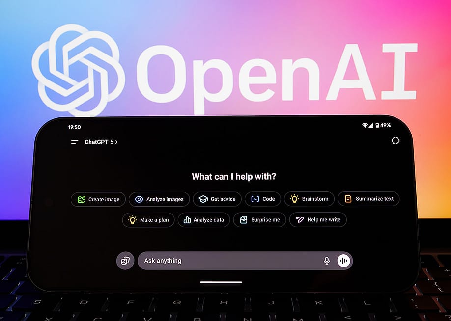 ChatGPT 5 interface on a phone with the logo of OpenAI in the background. — Ascannio // Shutterstock