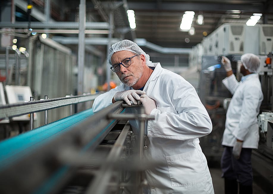 A focused factory engineer monitoring a production line. — wavebreakmedia // Shutterstock