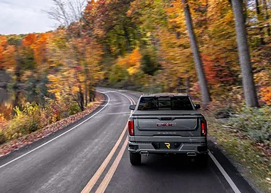 A truck driving down a highway. — RealTruck.com