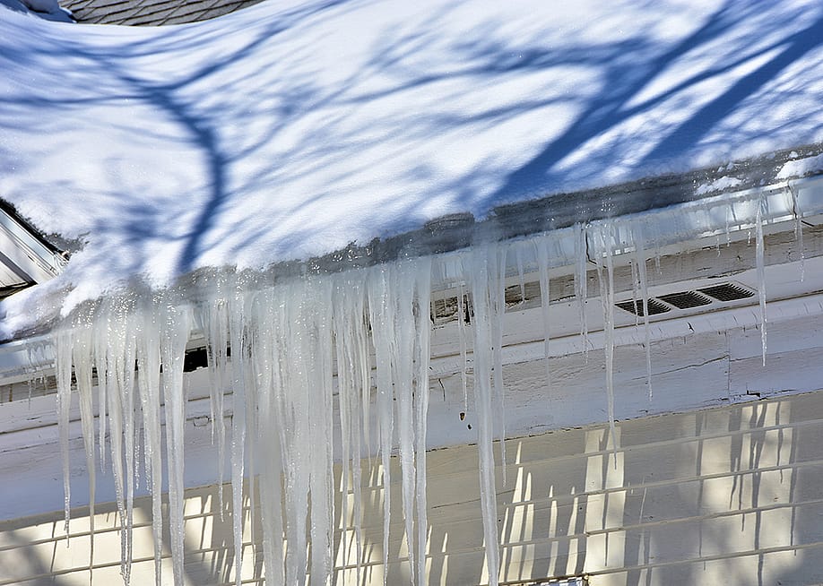 Ice built up in roof gutters. — northlight // Shutterstock