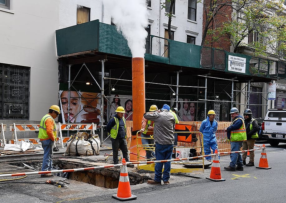 A team of workers on a roadside construction site in New York. — 18th Studio // Shutterstock