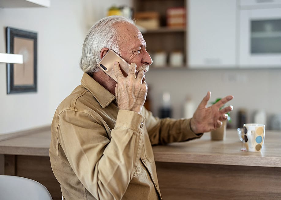 A happy senior man talking on the phone. — Jelena Stanojkovic // Shutterstock