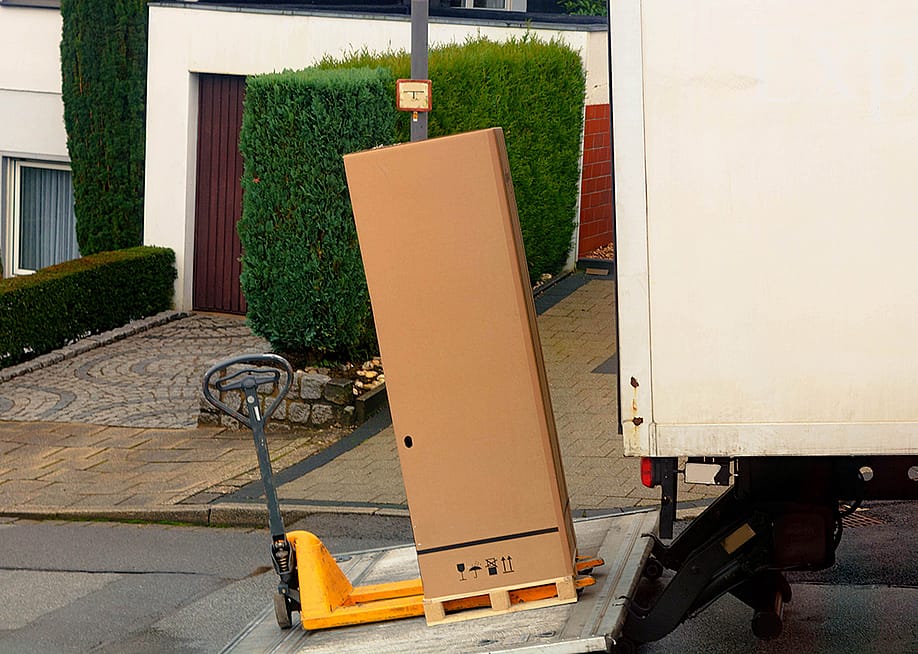 A large parcel box being loaded in a shipping truck. — John-Fs-Pic // Shutterstock