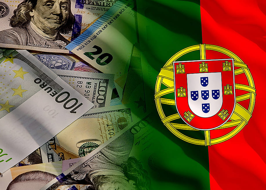 Flag of Portugal fading into a background of US and Euro banknotes. — Onur Akkurt // Shutterstock