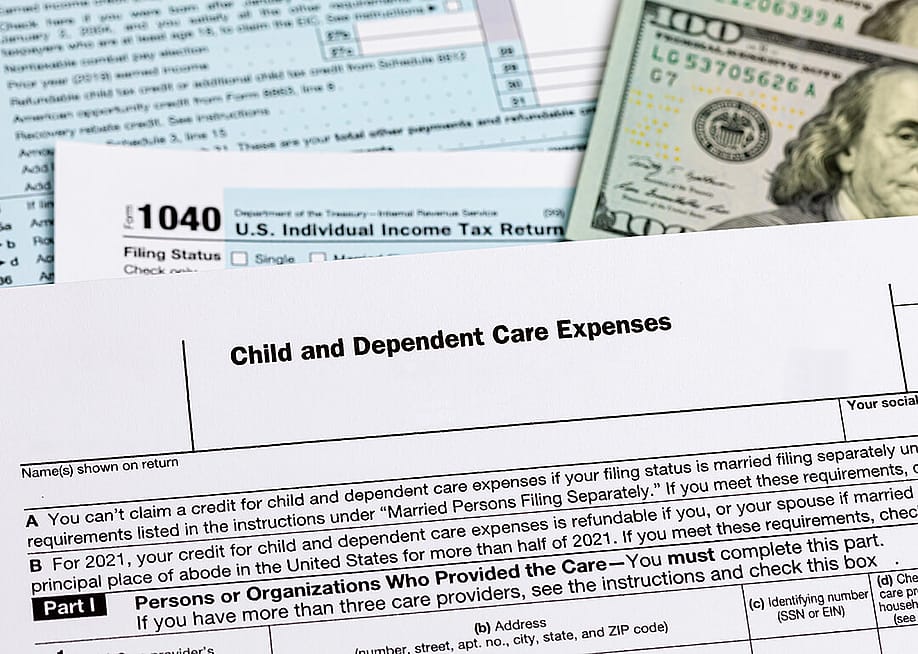 A 'child and dependent care expenses form on top of other US tax documents. — J.J. Gouin // Shutterstock