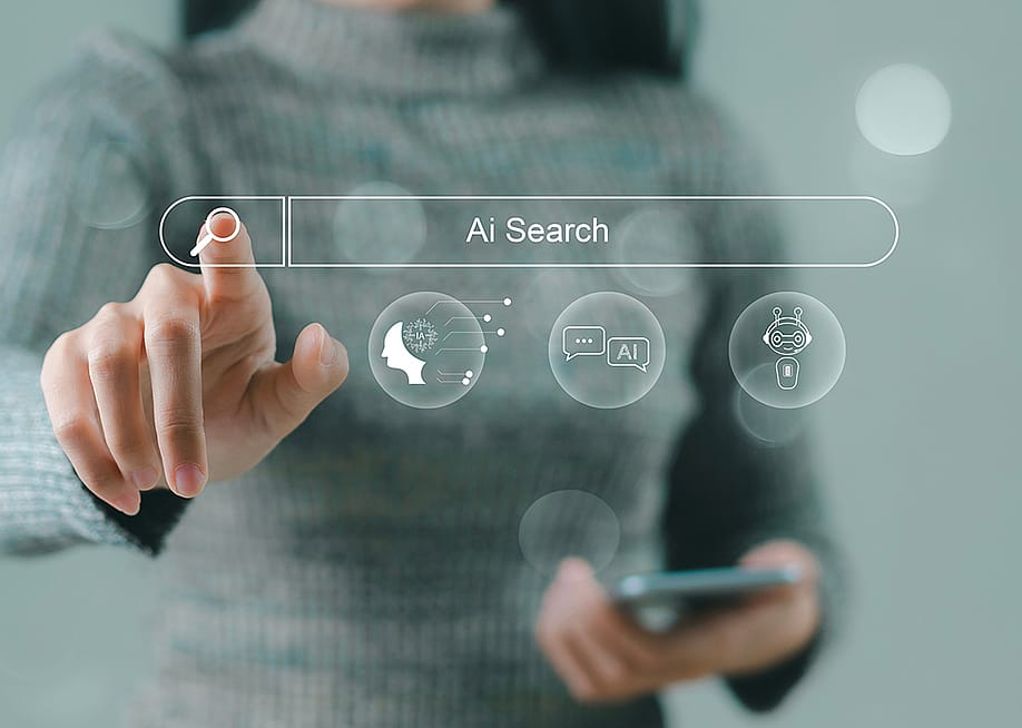 A businesswoman using a smartphone navigating a holographic AI search engine bar. — Panya_photo // Shutterstock