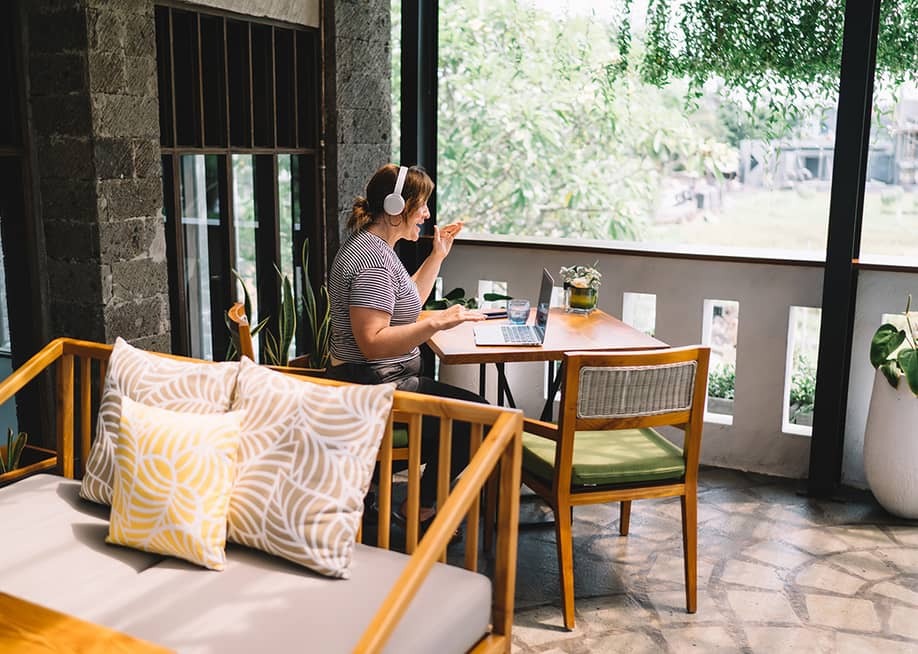 A freelancer working remotely from a home balcony. — GaudiLab // Shutterstock
