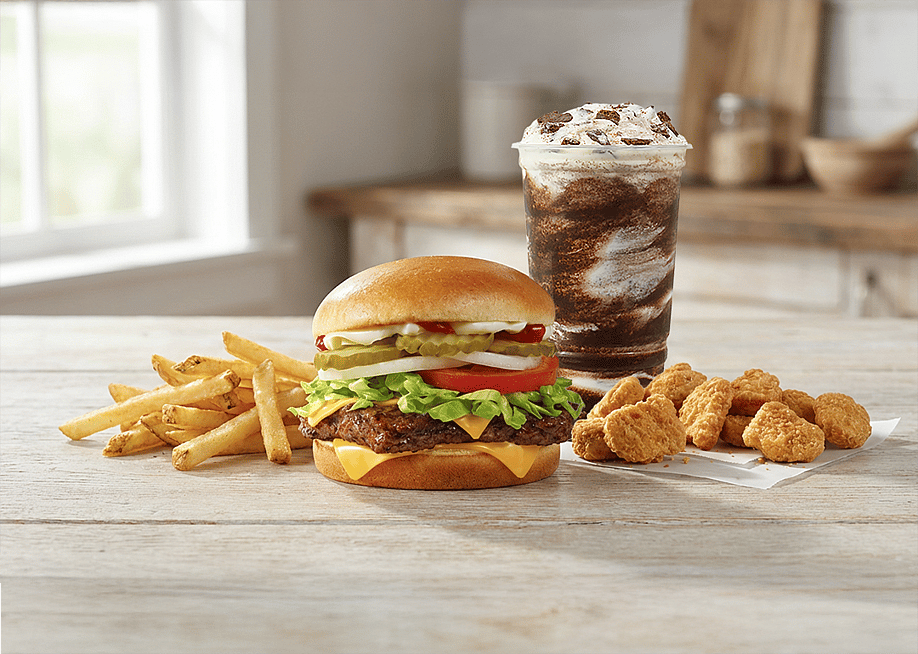 A burger meal with fries, chicken nuggets, and frosty drink. — Wendy's