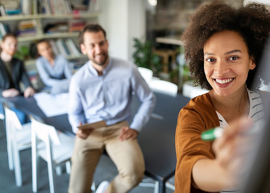 Employees collaborating during a meeting in the office. — NDAB Creativity // Shutterstock