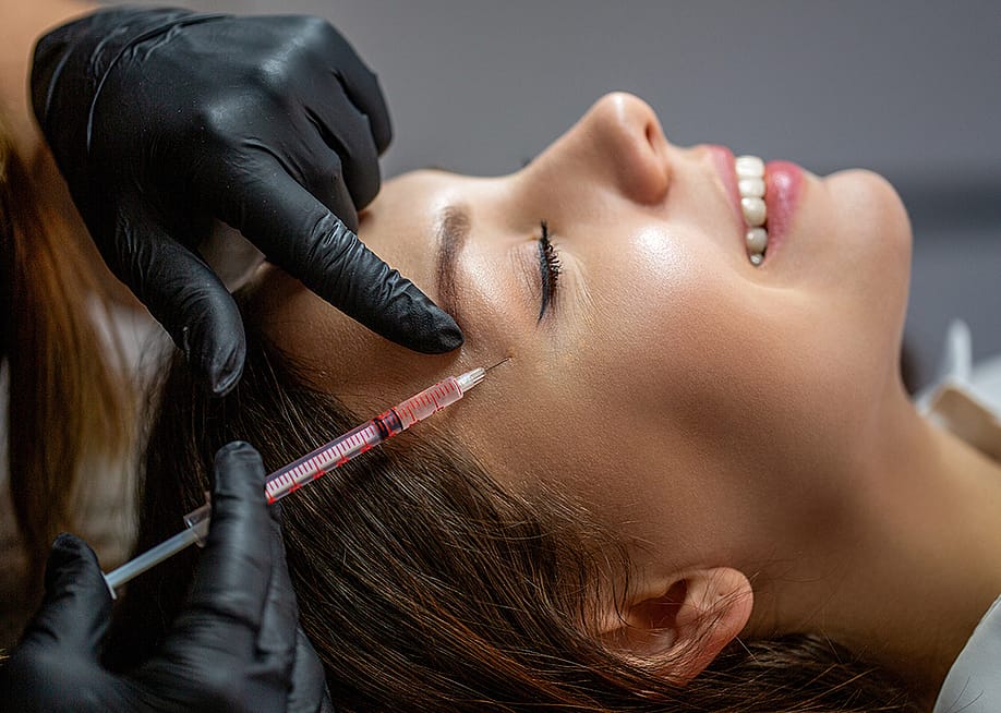 A person undergoing a botox procedure. — Body Stock // Shutterstock