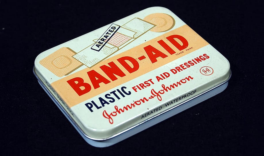 Early tin of Band-Aid — Wikimedia Commons // Alf van Beem