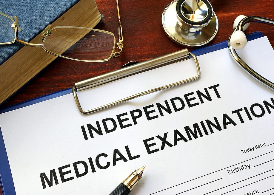 An independent medical examination form on a clipboard. — Vitalii Vodolazskyi // Shutterstock