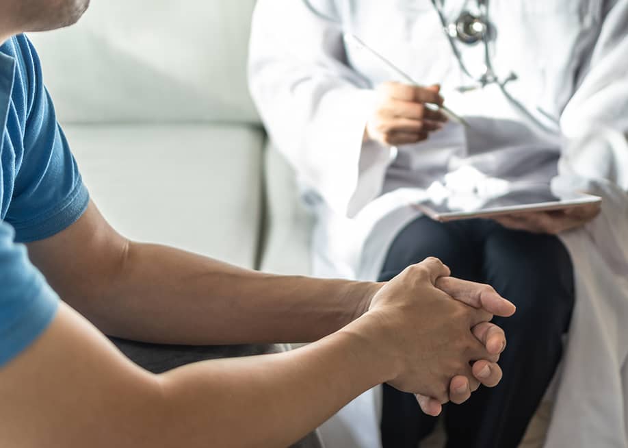 Man consulting with a doctor. — Chinnapong // Shutterstock