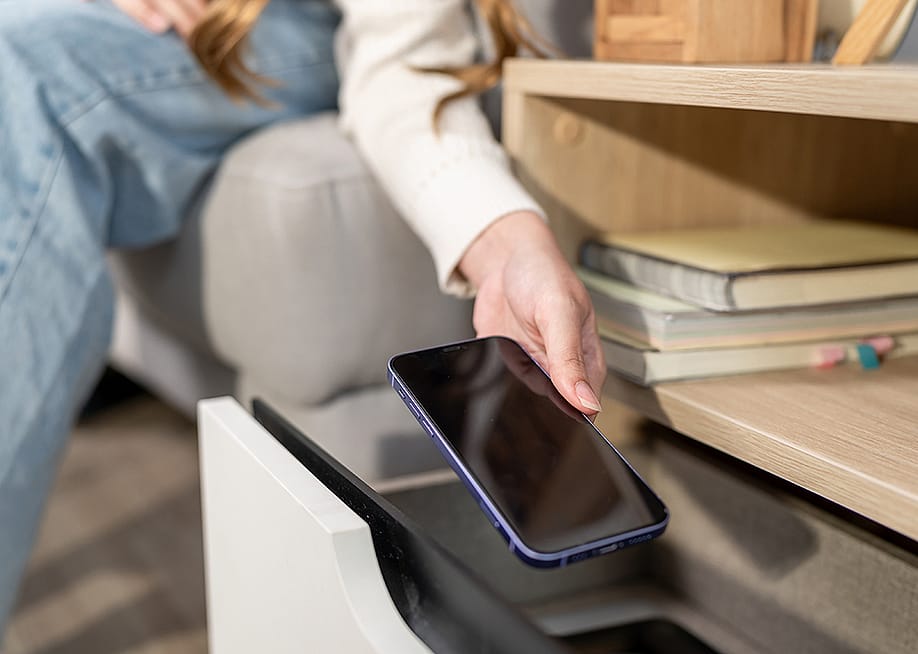 A person putting a smartphone inside a drawer. — Hananeko_Studio // Shutterstock