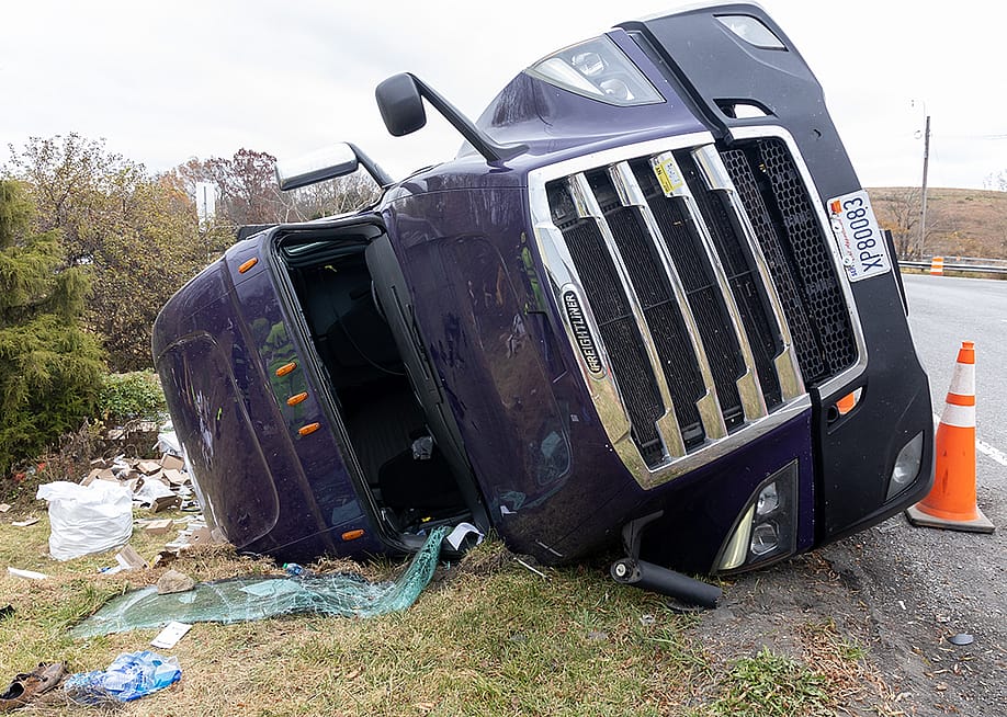 An overturned truck at the side of a road after an accident. — Kirkam // Shutterstock