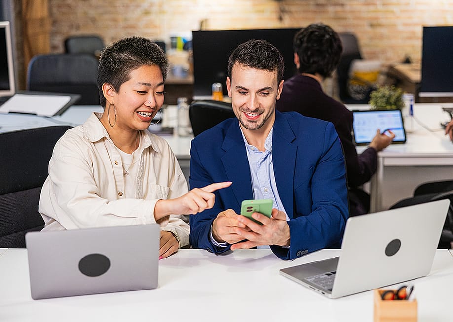 A diverse business team working together on a project in an office. — Jordi Mora // Shutterstock