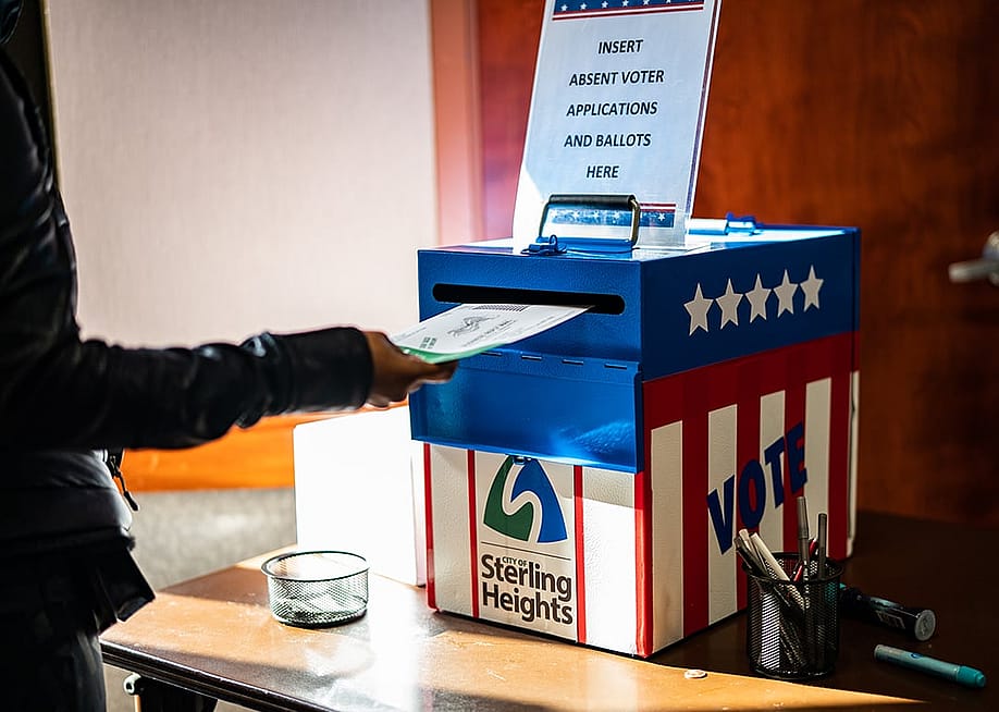 A voter casting an absentee ballot at the Sterling Heights Election Center in Michigan, USA. — Salwan Georges // The Washington Post via Getty Images