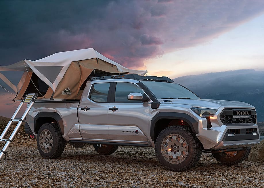 Silver 2023 Toyota Tacoma Truck with a tent built out for camping covering the truck bed. — Mike Mareen // Shutterstock