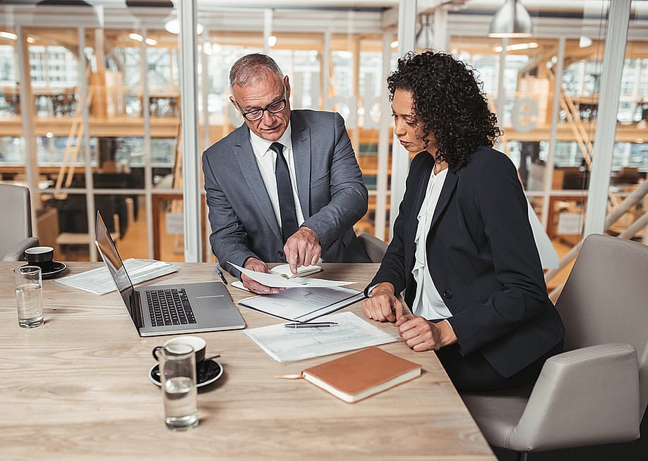 Two business executives reviewing a report. — mavo // Shutterstock