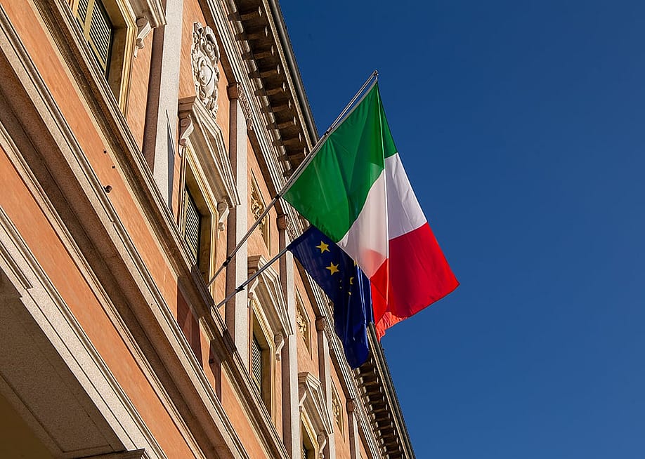 Italy and European Union flags on a balcony of a building in Reggio Emilia City, Italy. — francesco de marco // Shutterstock