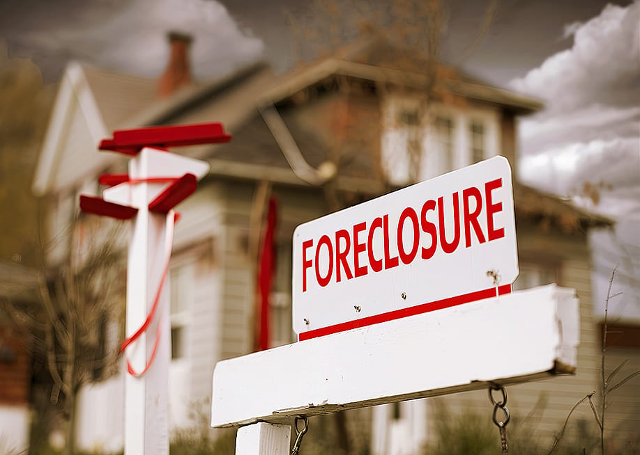 A foreclosure sign seen in front of a house. — videogutiums32 // Shutterstock