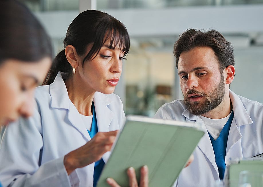 A team of doctors in office for a medical case review. — PeopleImages // Shutterstock