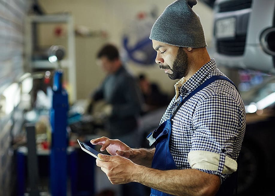 A mechanic using a tablet to process an order. — Pressmaster // Shutterstock