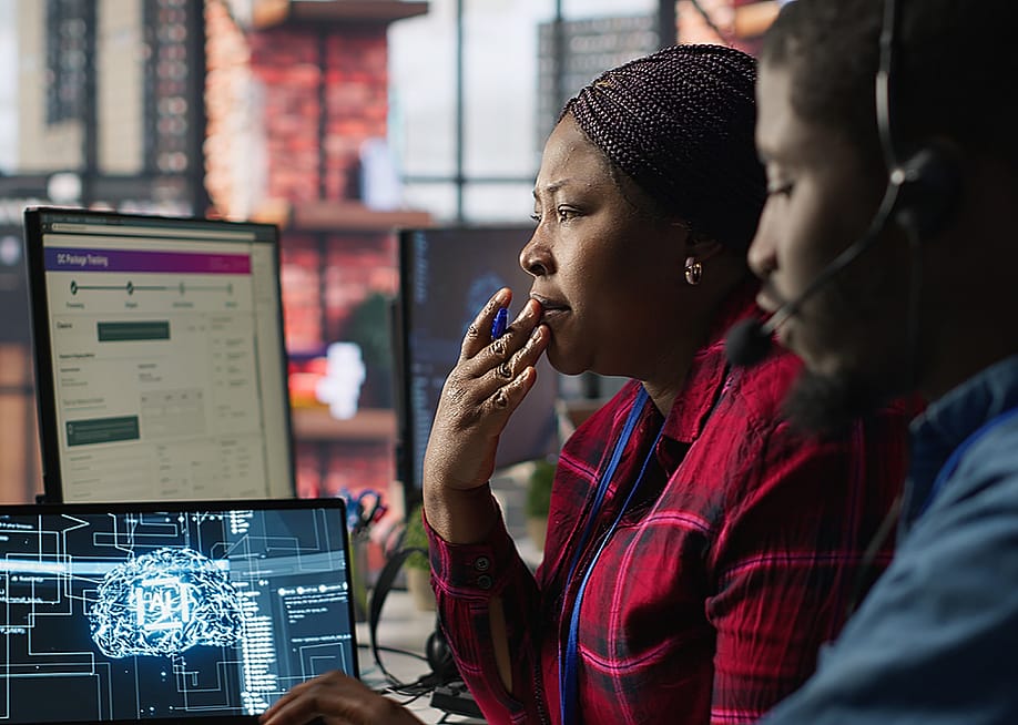 Customer service agents brainstorming together with AI chatbot. — DC Studio // Shutterstock