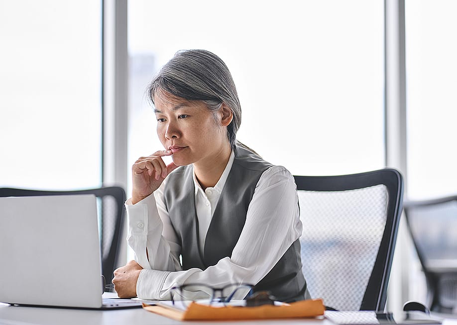 A business manager reviewing work tasks in an office. — insta_photos // Shutterstock