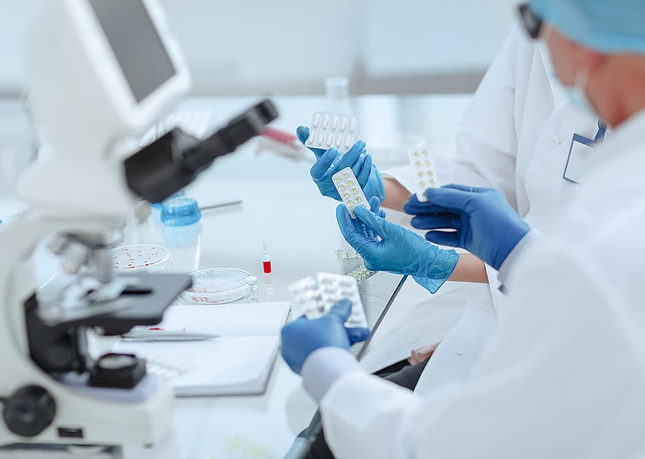 Pharmacists reviewing a new drug in a laboratory. — SmartPhotoLab // Shutterstock